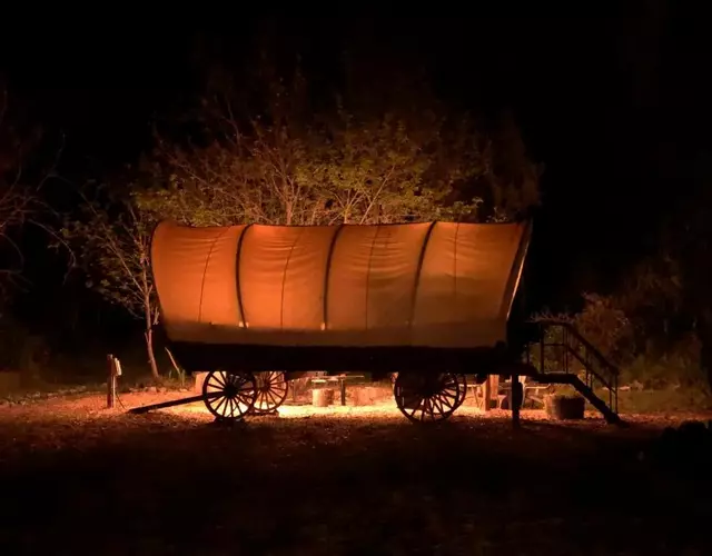 Cozy Wild West Covered Wagon next to River