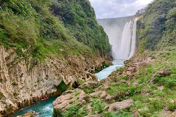 Tamul waterfall and water cave on a wooden canoe