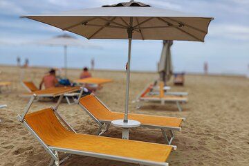 A Parasol and Two Sunbeds On Our Beach in Rimini