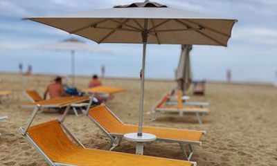 A Parasol and Two Sunbeds On Our Beach in Rimini