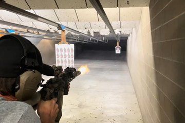 Sharp Shooters Indoor Range experience with a wall of guns