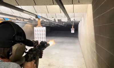 Sharp Shooters Indoor Range experience with a wall of guns