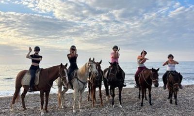 Horseback riding through the pine forest and along a natural beach